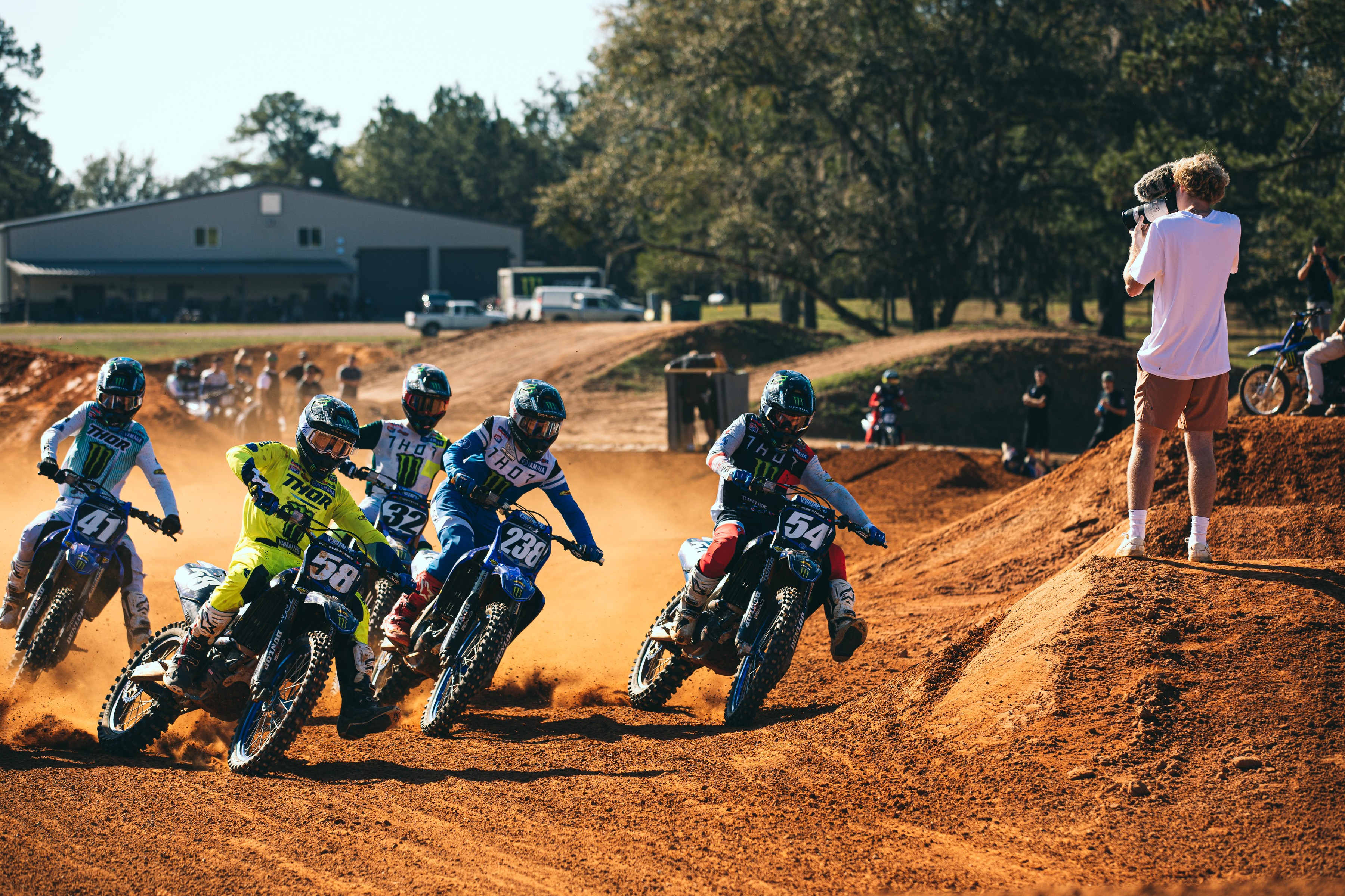 Blake McCann filming the start of a motocross race from the edge of the track